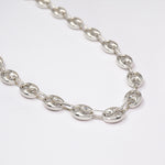 Chunky Silver Gucci chain on a white background