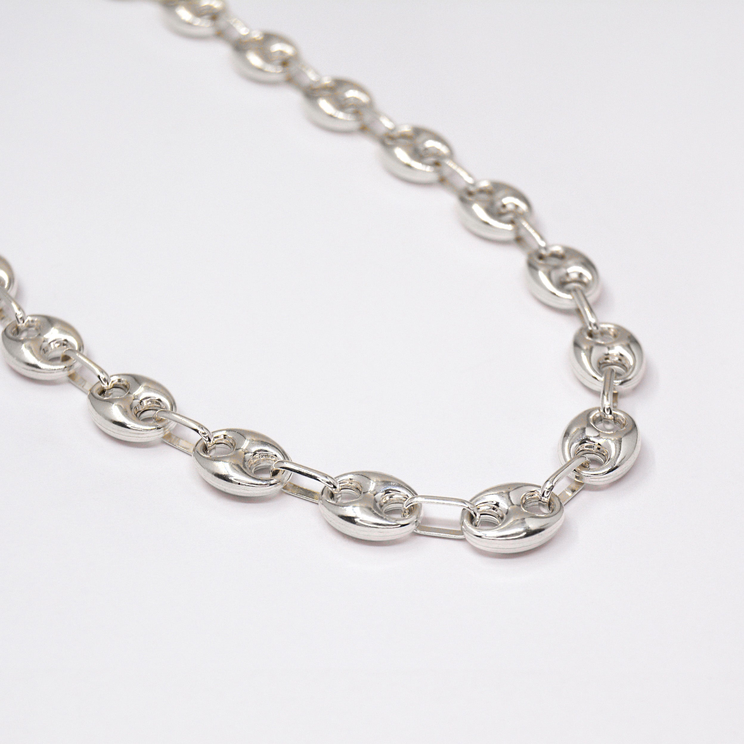 Chunky Silver Gucci chain on a white background