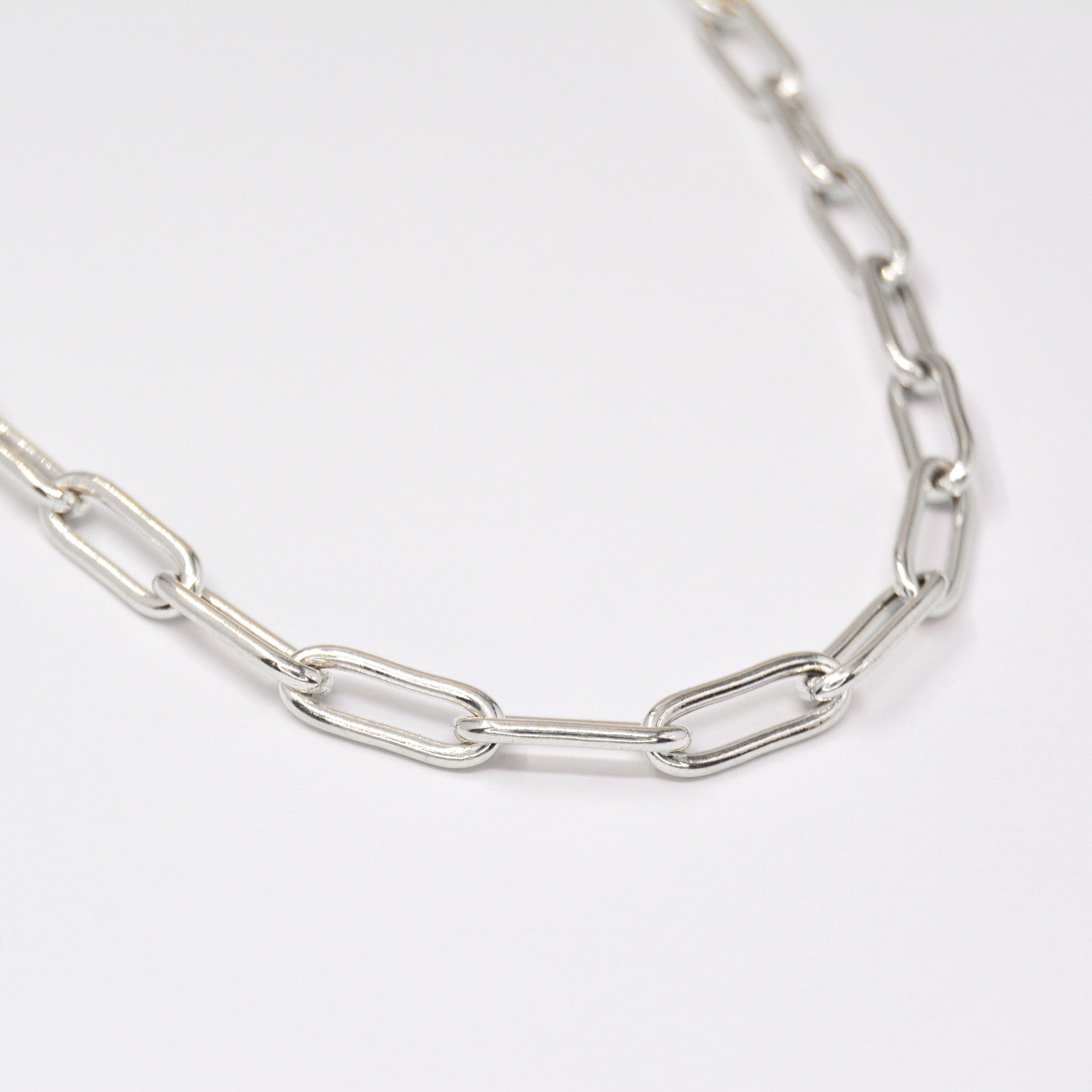Silver Paperclip chain on a white background