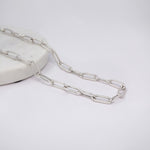 Silver Paperclip chain necklace on a light gray background