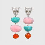 Pair of earrings with leopard face design and colorful gemstones on a light gray background