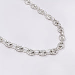 Silver chain necklace on a light gray background