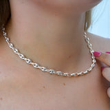 Silver Gucci chain necklace being worn on a person's neck