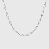 Silver Paperclip chain on a light gray background