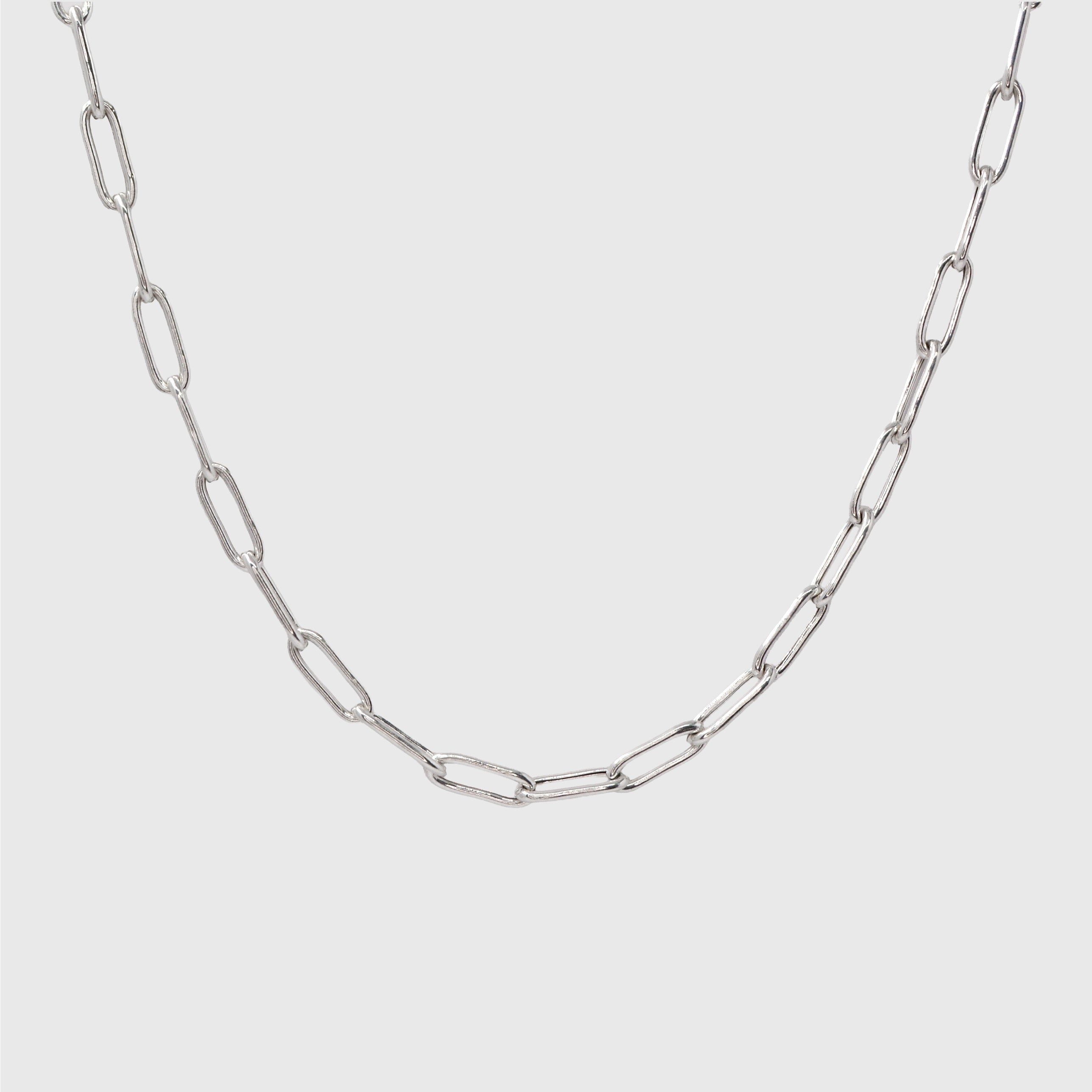 Silver Paperclip chain on a light gray background