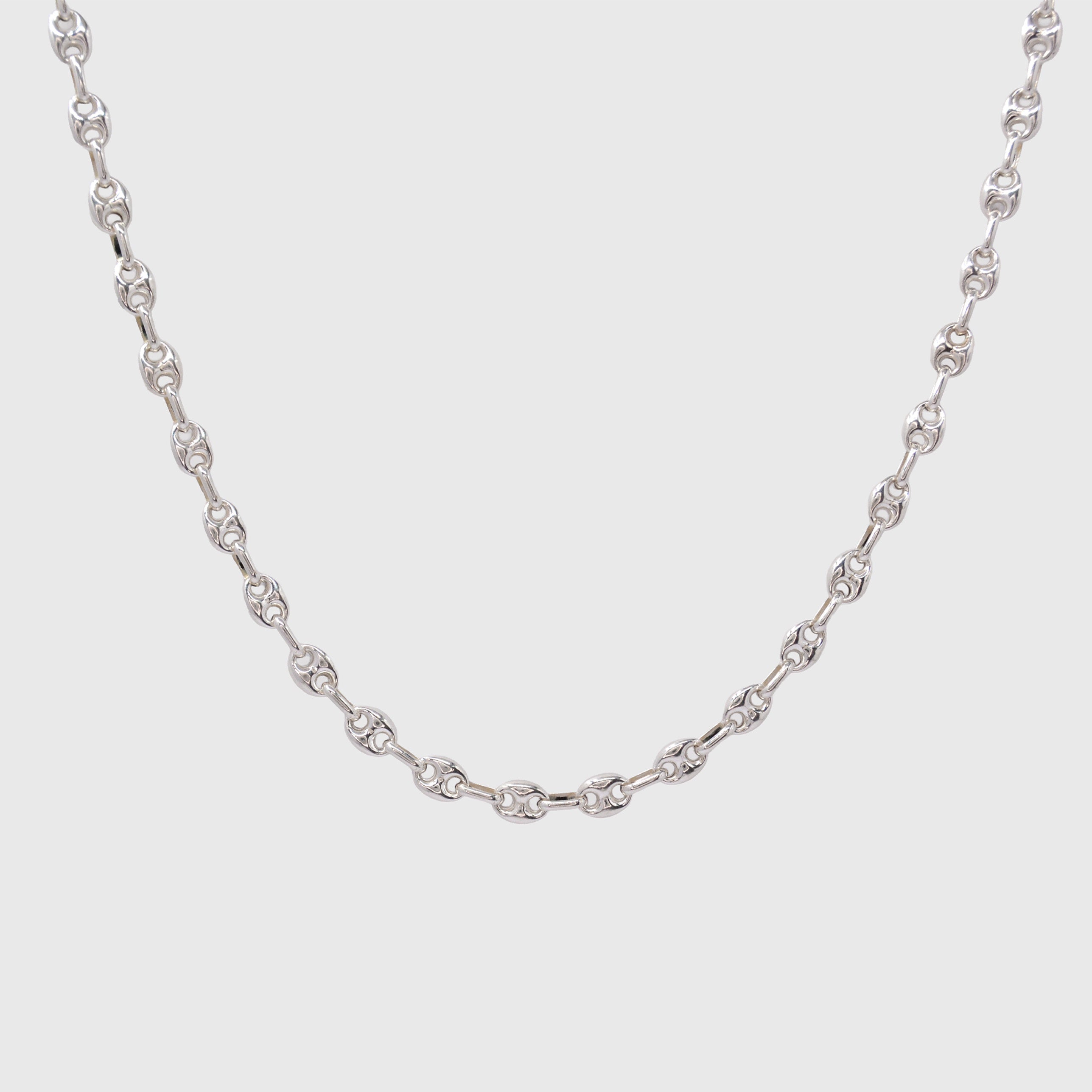 Silver Gucci chain necklace on a light gray background