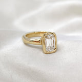 Adore old-cut lab-grown diamond engagement ring in 9ct yellow gold with a textured bezel, resting on white satin