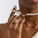 Adore lab-grown diamond engagement ring in 9ct yellow gold stacked with gold bands, worn with a leopard-head pearl choker