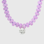 Close-up of the silver smiling sun charm hanging between lilac agate beads on lilac knotted thread