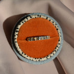 Nouveau lab-grown princess-cut diamond wedding band in 9ct yellow gold in a rust velvet ring box