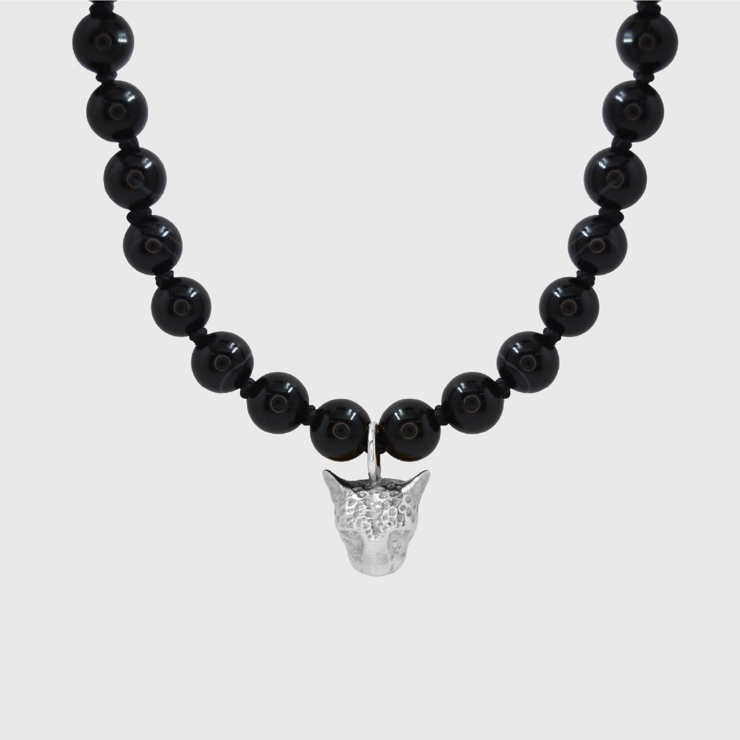 Black beaded necklace with a silver leopard face pendant on a white background