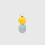 Hoop charm with a round mango jade bead above a barrel-shaped aquamarine on a silver loop