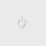 A silver heart-shaped pendant charm with small silver bead accents along the outer edge, shown on a light gray background.