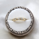 Truly marquise and round lab-grown diamond wedding band in 9ct yellow gold in a speckled linen ring box, viewed from the top