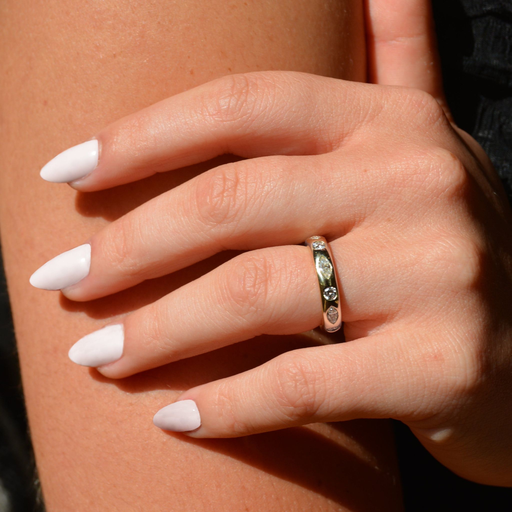 Truly marquise and round lab-grown diamond wedding band in 9ct yellow gold worn on the ring finger